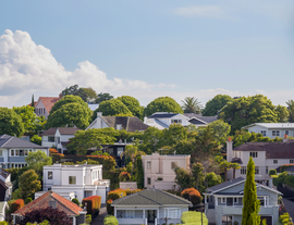 A suburban view showing multiple houses and blue skies listing.png