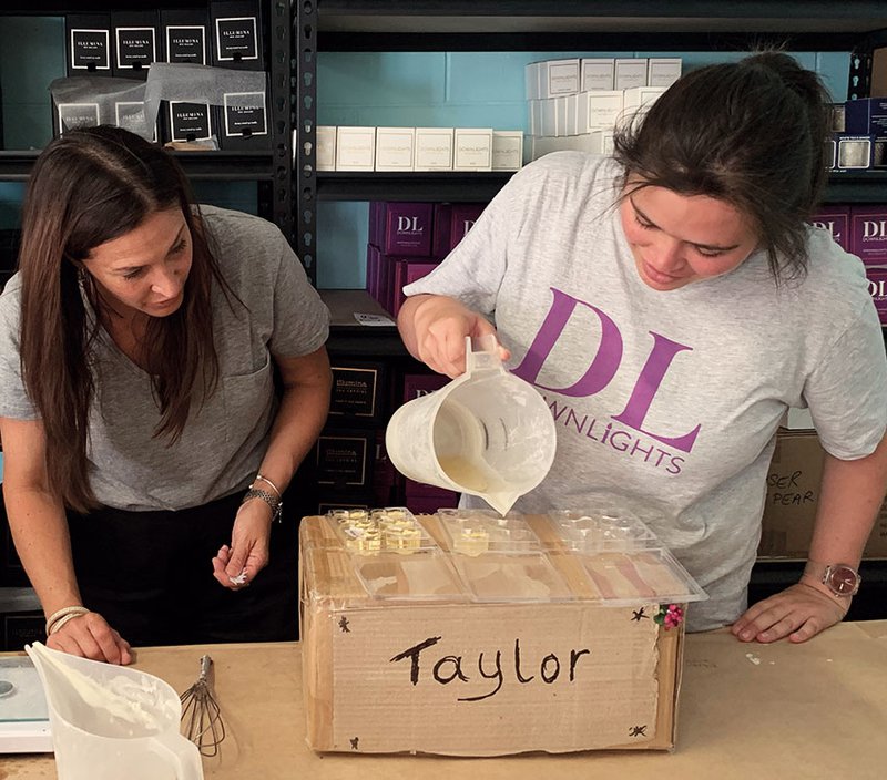 Downlights managing director Jennifer Del Bel pours candles with Taylor Brown