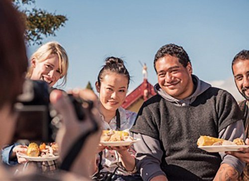 Group sharing a meal embodying manaakitanga or hospitality