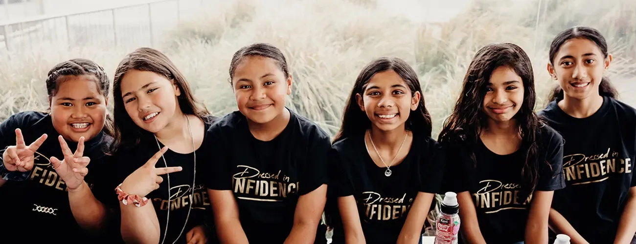 Group of girls wearing Dressed in Confidence shirts