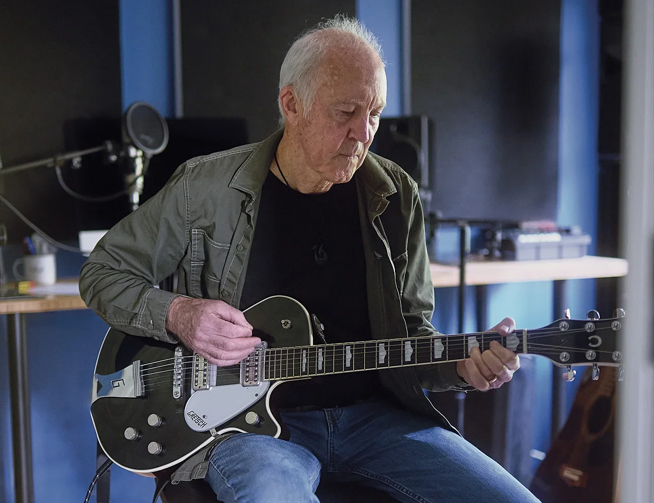 Mac Mckay playing his guitar in a studio