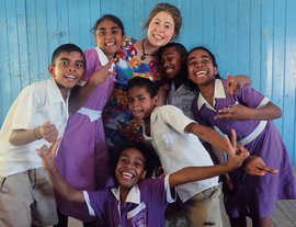 Olivia Gray with students while volunteering at a school in Fiji