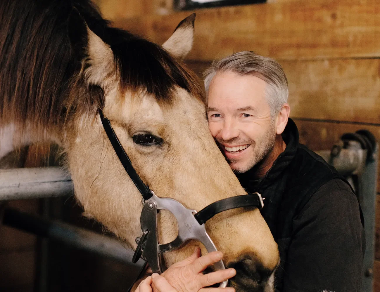 Ōtaki veterinarian Ray Lenaghan hugging a horse