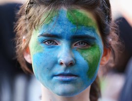 Portrait of young person with face paint of the earth