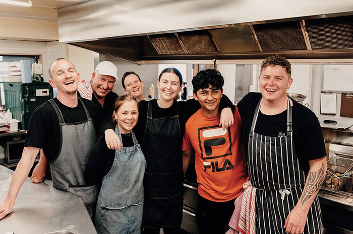 Professional chefs are helped by volunteers at Everybody Eats