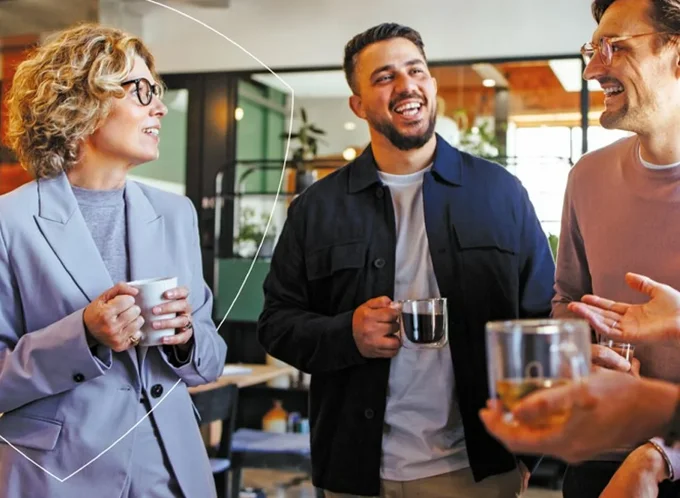 Some colleagues talking in an office with tea  - listing