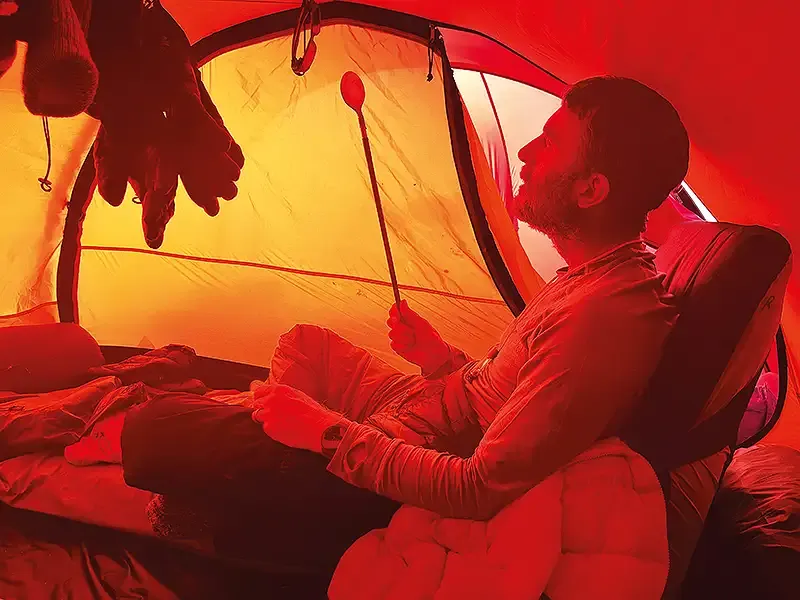 man camping in a tent - ends of the earth.webp