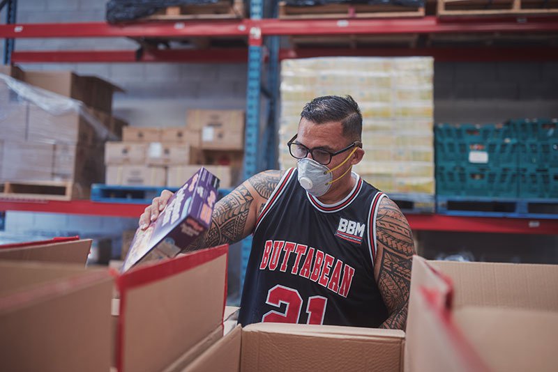 Dave Letele packing food boxes