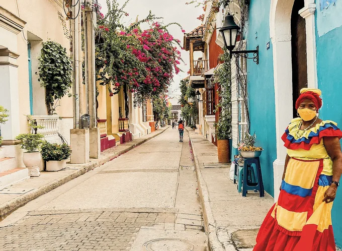 woman on a colourful street in colombia - listing