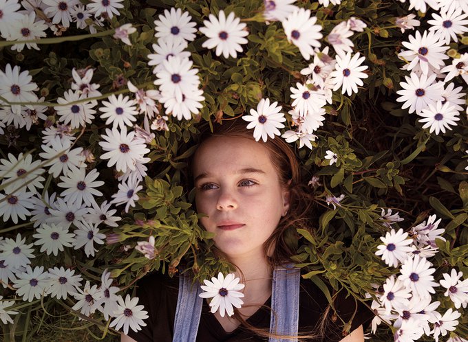 young-girl-lying-in-a-bed-of-flowers.jpg